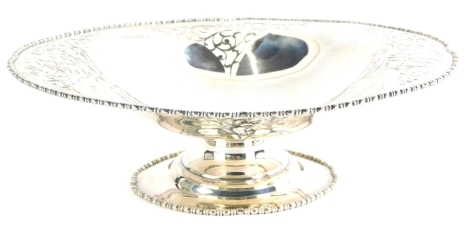 A George V silver dish, of shaped oval form, with part pierced body, on a squat stem and oval foot, London 1915, 28cm wide, 16oz.