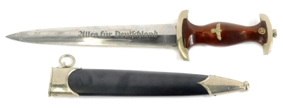 A Third Reich SA dagger, with emblem and eagle mounts to wooden handle, the blade stamped Alles Fur Deutschland and the maker Herman Konejung Solingen, with metal scabbard, 37cm long.