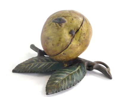 An early 20thC cold painted metal money box, modelled in the form of an apple with a beetle and leaf, 15cm wide.