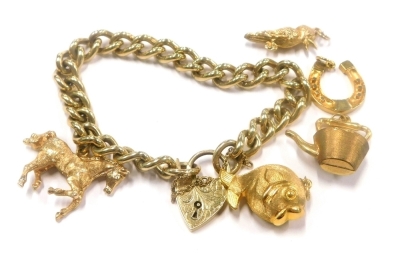 A 9ct gold curb link chain, mounted with a 9ct gold horse shaped charm, and four further 9ct gold charms, 49.9g all in.