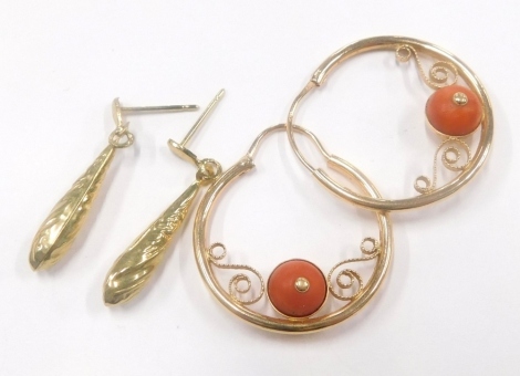 Two pairs of 9ct gold earrings, to include a pair of 9ct gold hoop earrings, each set with single coral bead and another pair of drop earrings, with floral scroll design, 4.6g all in. (2)