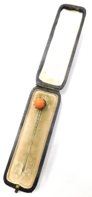 A coral set stick pin, in a silver plated claw setting, on a steel pin, 5.5cm high, boxed.