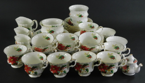 A Royal Albert Poinsettia part service, to include tea cups, miniature teapot, 7cm high, side plates, bowls, printed marks beneath. (a quantity)