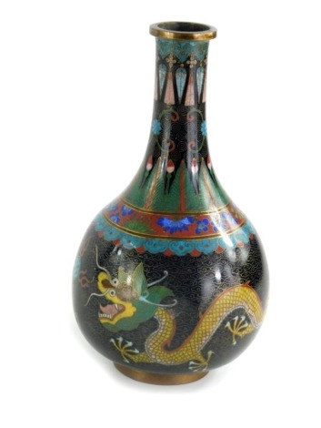 A 20thC Chinese cloisonne vase, of bulbous form with cylindrical stem, profusely decorated with a five claw dragon and acanthus leaves, predominantly in blue on a black and gilt highlighted ground, 22cm high.