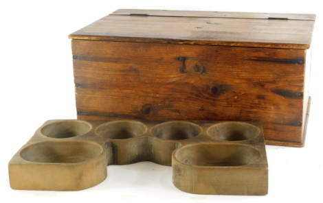 Bygones and collectables, an early 20thC sectional mould, possibly a pie mould, 39cm wide, and a Teachers advertising pine box of rectangular form with hinged lid, stenciled and printed with whisky bottles., (2).