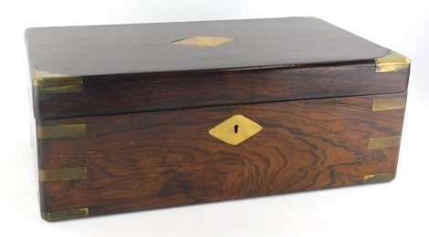 A 19thC and later rosewood campaign writing box, of rectangular form, with flush handles and brass dovetails, with a brass diamond escutcheon, the sloping lid hinging to reveal a fitted interior with tooled leather section space for ink bottles and pens, 
