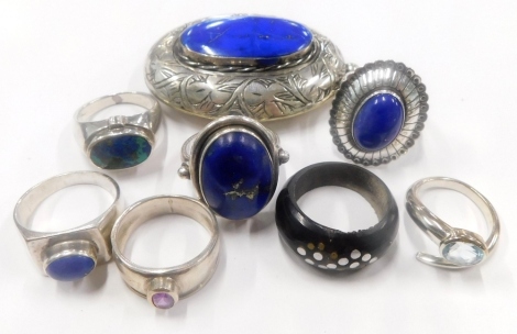 A group of silver jewellery, to include a silver locket, group of silver dress rings, each set with lapis and a wooden dress ring. (a quantity)