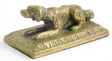 A Victorian cast brass paperweight, modelled in the form of recumbent hound, 11cm wide.