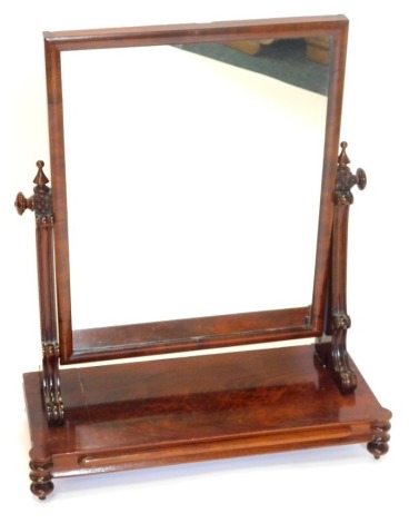 A Victorian figured mahogany dressing table mirror, rectangular shaped on shaped supports, with platform base with bun feet, 47cm wide.