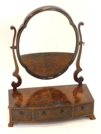 A burr walnut dressing table mirror, with a shaped plate on scroll supports, the bowfronted box base with three drawers, on ogee bracket feet, 50cm wide.