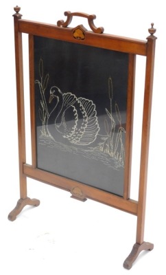 An early 20thC mahogany Art Nouveau style firescreen, with inlay of leaves and a later embroidered banner depicting a swan, 94cm high, 62cm wide.