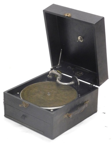 A wind up gramophone, in black wood and canvas case, maker's label indistinct, HMV stylist, etc., 34cm wide.