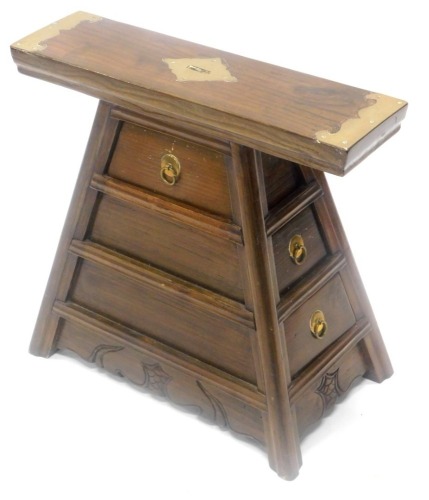 A oriental small cabinet, the rectangular top with brass mounts and a slot above three graduated drawers, 46cm wide.