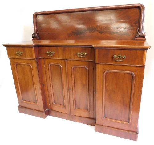 A 19thC mahogany inverted breakfront sideboard, with an associated raised back above three frieze drawers and an arrangement of four doors, each with arched panels on a plinth, 130cm high, 153cm wide.