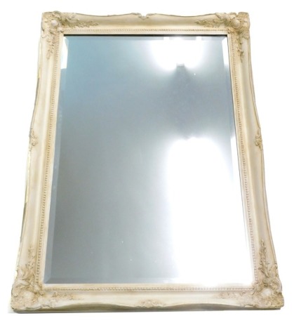 A cream painted wall mirror with bevel plate, 106cm high, 76cm wide.