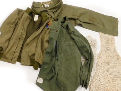 A Second World War winter combat jacket, size Medium, label for De Brander Co, dated February 29 1942, string vests dated from 1943-45, a pair of Drab green army trousers size 5 by Denham (1933) Ltd dated from 1942, a green, Shirt Jungle, size 15.5 x 34,