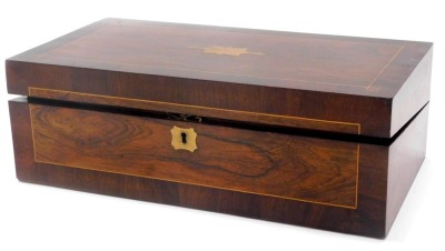 A Victorian mahogany and rosewood writing box, the hinged lid with vacant brass cartouche enclosing a fitted interior, 46cm wide.