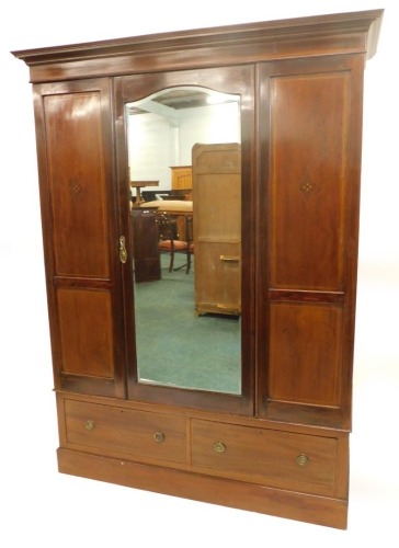 An Edwardian mahogany and inlaid wardrobe, the central mirror door, above two drawers, 206cm high, 153cm wide.