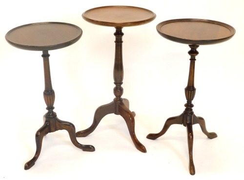 Three mahogany wine tables, each with a dished top, a turned column and a tripod base, 53cm, 57cm and 52.2cm high respectively.