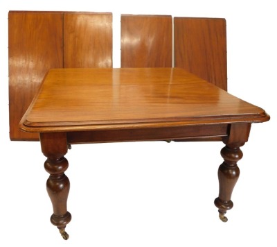 A Victorian mahogany extending dining table, the rectangular top with a moulded edge on turned tapering legs on brass castors, four loose leaves, 72cm high, the top 122cm x 336cm.