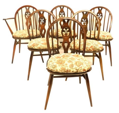 A set of six Ercol beech and elm Windsor chairs, each with a pierced splat, a solid seat on turned legs.