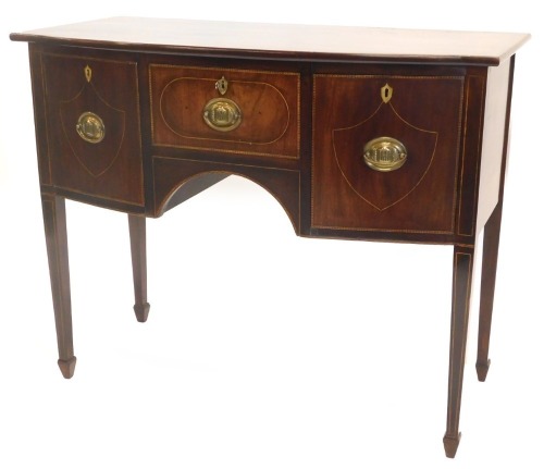 A George III mahogany, boxwood strung and feather banded small sideboard, with a bow fronted top, above a central frieze drawer, flanked by two doors, on square tapering legs, 87cm high, 108cm wide.