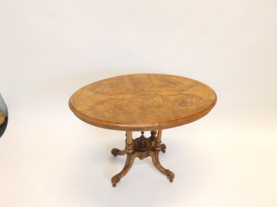 A Victorian walnut occasional table, the circular quarter veneered top with inlaid border on four turned supports with carved and splayed legs and ceramic castors, 71cm high, 90cm wide. - 2