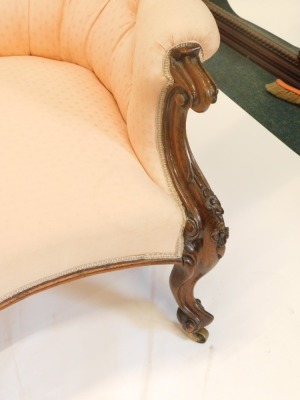 A Victorian rosewood showframe chaise lounge, upholstered in coloured fabric on scroll carved legs, with castors. - 2