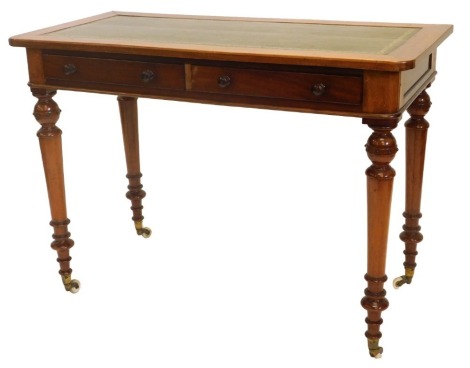 A Victorian mahogany writing table, the rectangular top with a later green leather insert, above two frieze drawers on turned tapering legs with ceramic castors, 108cm wide.