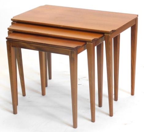 A nest of three G-plan type teak tables, each with a rectangular top on square tapering legs, the largest 66cm wide.