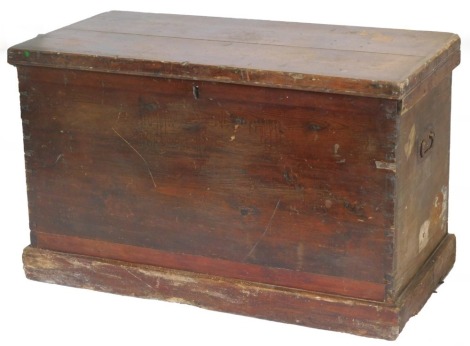 A Victorian stained pine travelling chest, the hinged lid enclosing a vacant interior, on a plinth, luggage label for Alan Line, Liverpool, 95cm wide.