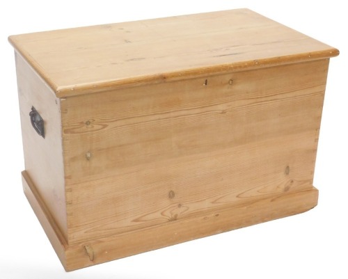 A stripped pine blanket box, the rectangular lid enclosing a vacant interior, on a plinth, 85cm wide.