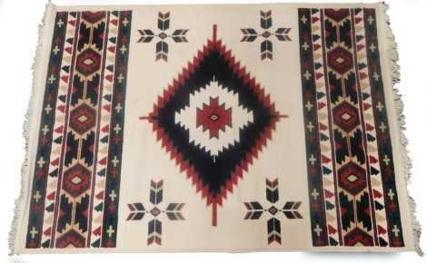 A modern rug, with a geometric design on a cream ground, 119cm x 165cm.