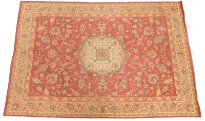 A Laura Ashley Belgian cotton rug, on a red ground, 136cm x 200cm.