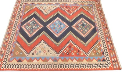 A Kilim rug, with a geometric design in cream, blue, navy, etc., 182cm x 229cm.