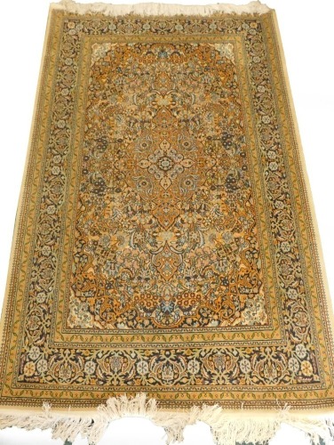 A Persian type mercerised cotton rug, with a central medallion, surrounded by an all over pattern of flowers, leaves, etc., one wide and various narrow borders, 201cm x 124cm.