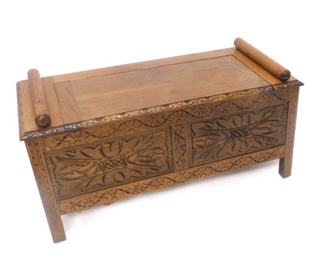 An early 20thC carved oak hall bench, with hinged lid, panel front on stiles, 104cm wide.