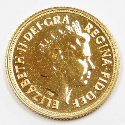 An Elizabeth II full gold sovereign, dated 2014, in plastic coin casing. - 2