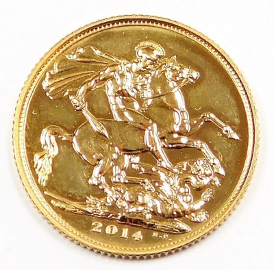 An Elizabeth II full gold sovereign, dated 2014, in plastic coin casing.