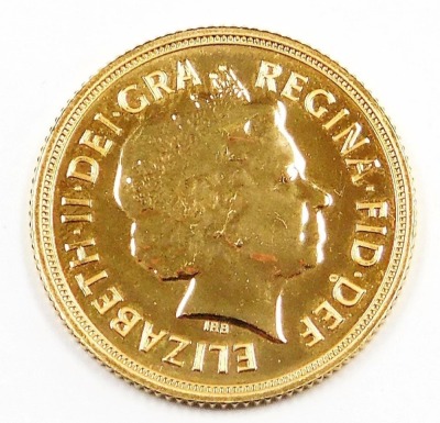 An Elizabeth II full gold sovereign, dated 2014, in plastic coin casing. - 2