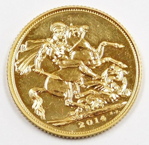 An Elizabeth II full gold sovereign, dated 2014, in plastic coin casing.