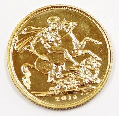 An Elizabeth II full gold sovereign, dated 2014, in plastic coin casing.