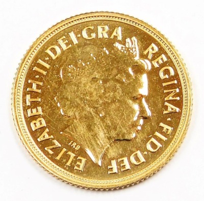 An Elizabeth II full gold sovereign, dated 2014, in plastic coin casing. - 2