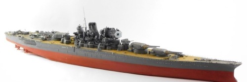 A scale model of a Japanese WWII battle ship, possibly The Yamato, modeled with armourments, deck planes, etc., 131cm wide.