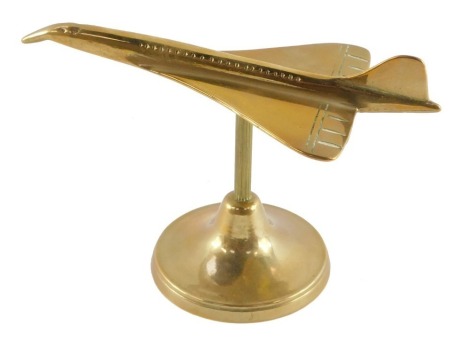 An aeronautical brass desk stand, modelled as Concorde 18.58, 18.5cm wide.