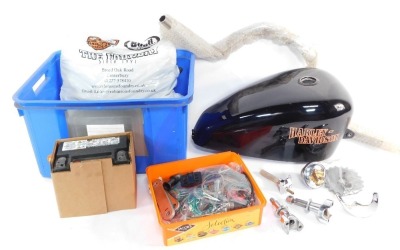 A Harley Davidson fuel tank, handle bar and assorted Harley Davidson spares.