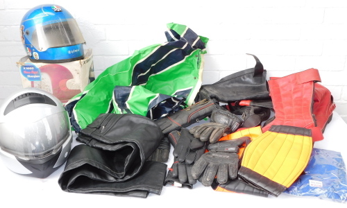 Assorted motorcycle boots, gloves and clothing, together with an AGV X3000 fibreglass motorcycle helmet, and a further motorcycle helmet. (2 boxes)