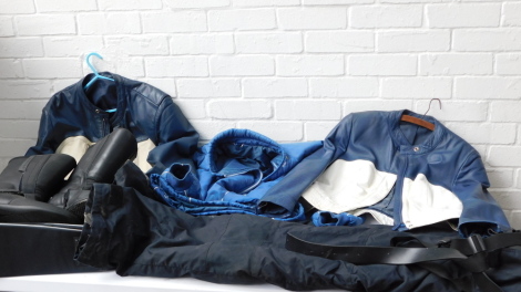 BMW motorcycle apparel, comprising two leather jackets, a pair of boots, a bag, light jacket and trousers.