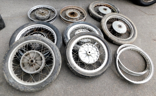 Nine motorcycle spoke wheels, two frames, with seven tyres.