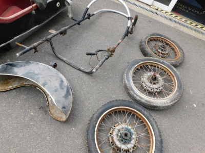 A motorcycle sidecar, together with three wheels, two for the bike, one for the sidecar, and a mudguard. - 4